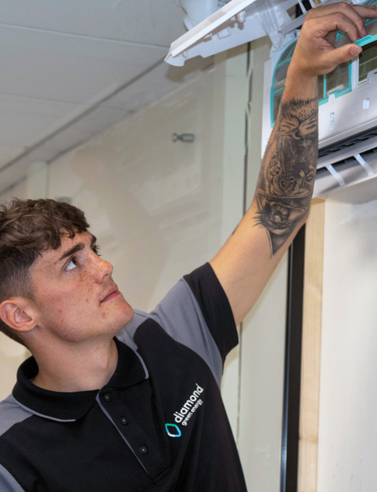 Diamond Green Energy engineer working on an air conditioning unit